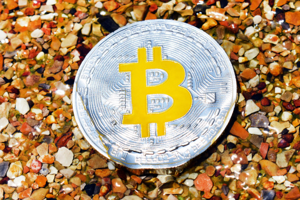 Bitcoin Yellow. A beautiful yellow Bitcoin sitting on a bed of stones.